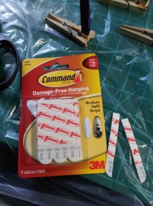 3M Command strips, with one cut in half down its length.